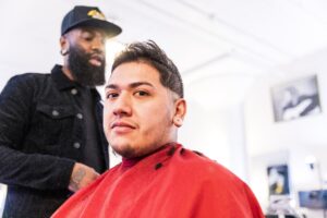 A latinx man gets a haircut 