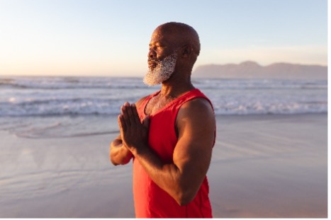 Man meditating on a beach