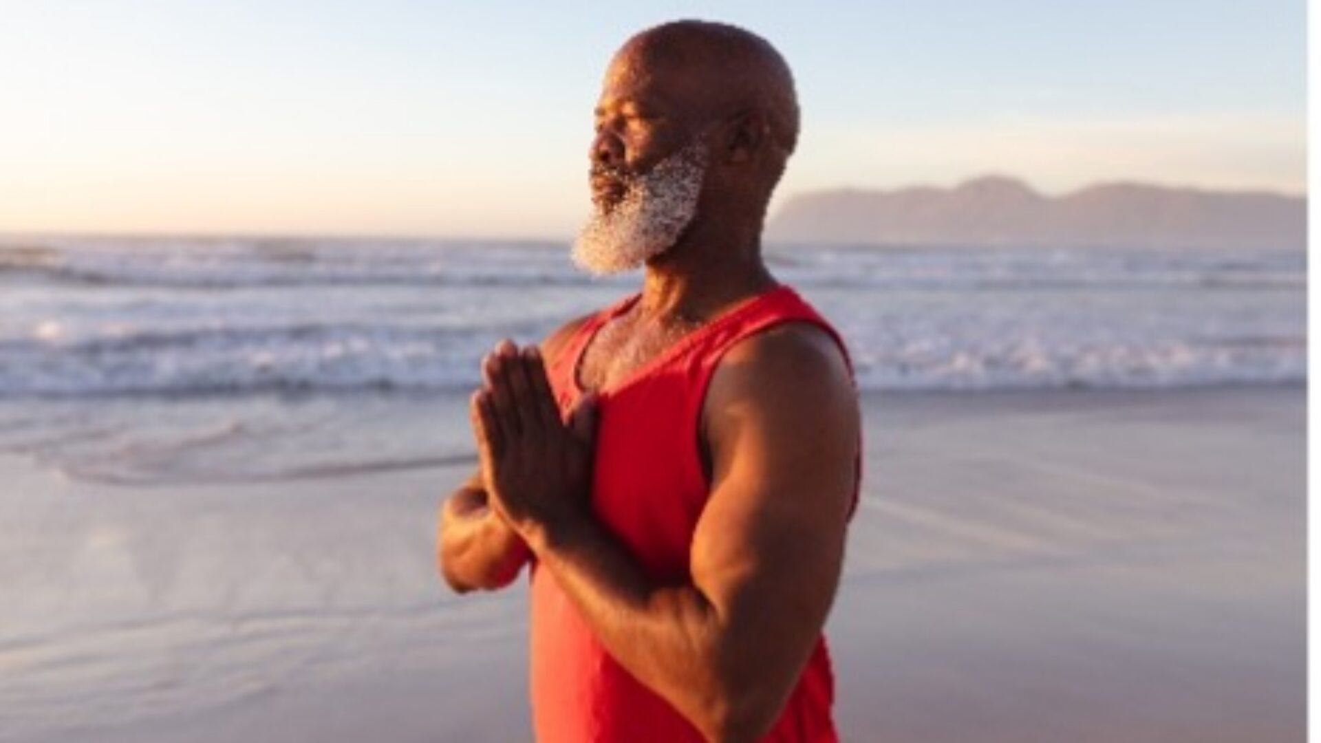 Man meditating on a beach