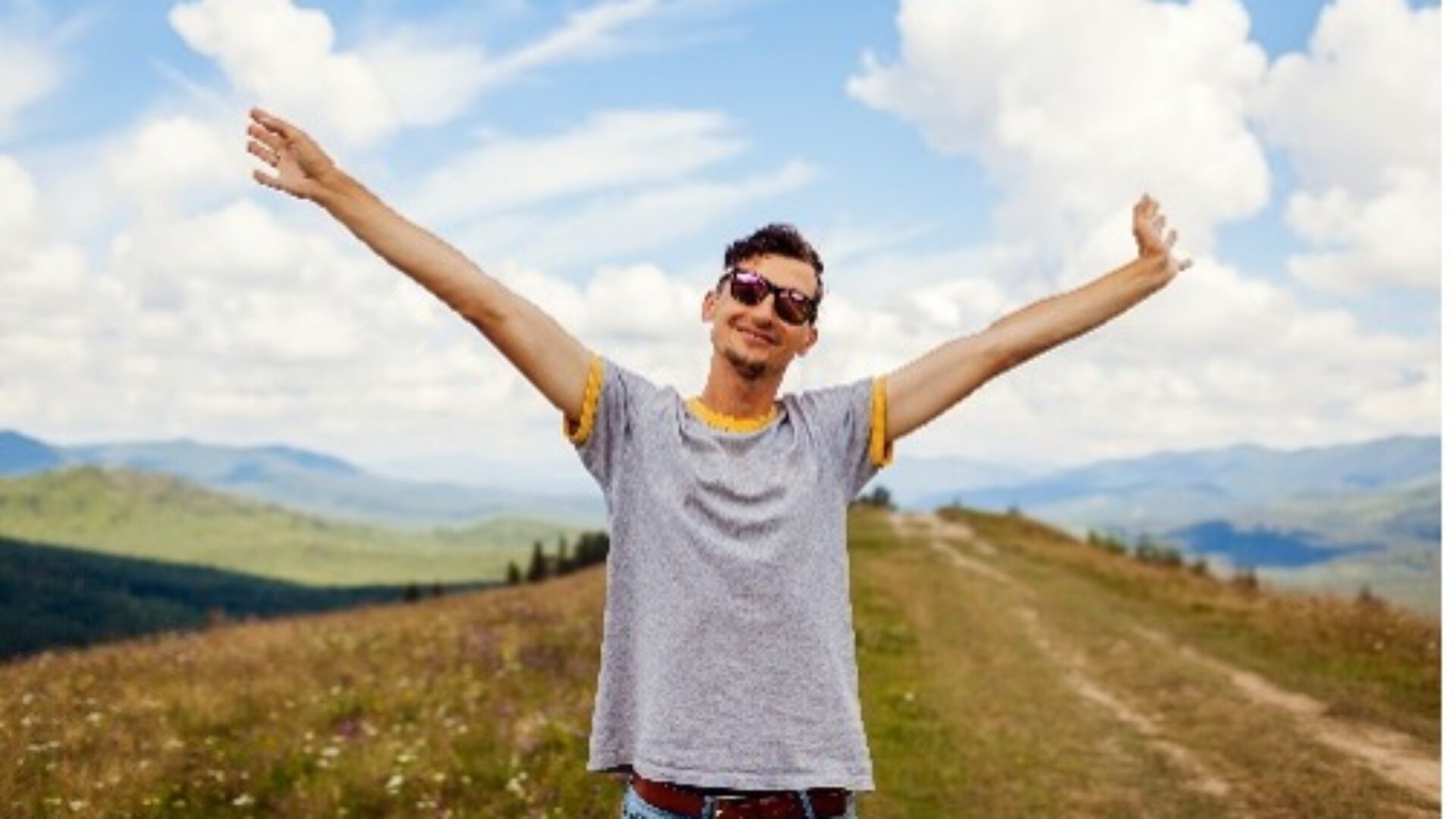 Person with their arms up in a field